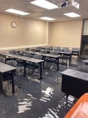 Water drips from the ceiling in a flooded Cooper Library classroom
