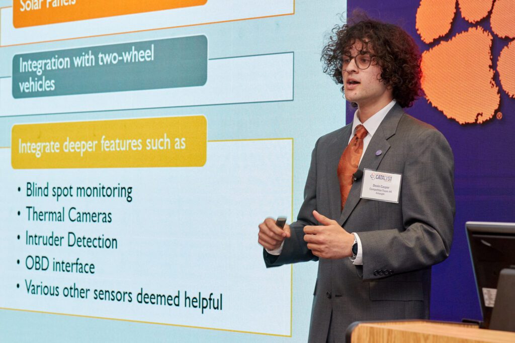 A Clemson student dressed in a suit, Devin Casper, presents his idea for a computer-assisted driver assistance system at the College of Science's Catalyst Competition.