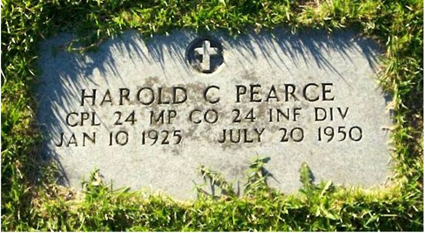 A grave stone with the name of Harold C Pearce surrounded by green grass