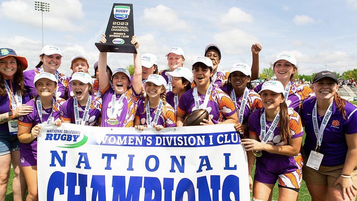 Members of the Clemson women's rugby club team hoist the 2023 national championship trophy on April 29