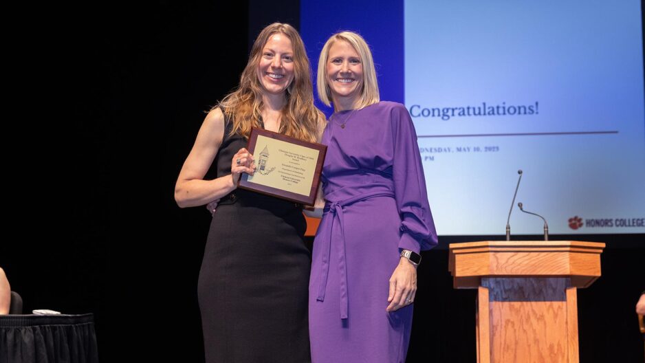 Amanda Cooper Fine holding her award and posing with Dean Sarah Winslow at the Honors College award ceremony on May 10, 2023.