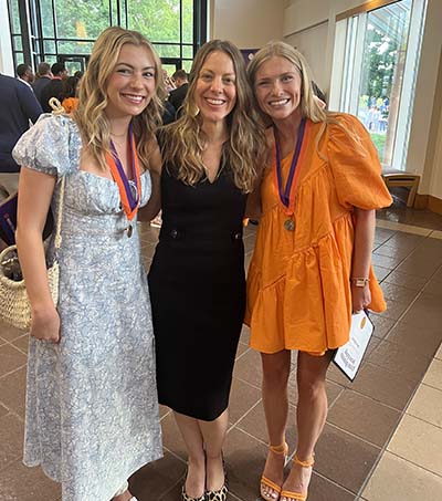 Riley Preiss, Amanda Cooper Fine and Delaney O'Tuel posing together at the Honors College awards ceremony in May 2023. 