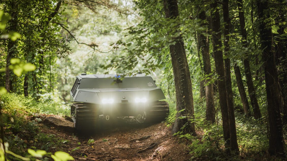 The Clemson University autonomous off-road vehicle, Deep Orange 14, tackles an obstacle-laden (rocks, uneven terrain, tree roots) dirt road in a forest.