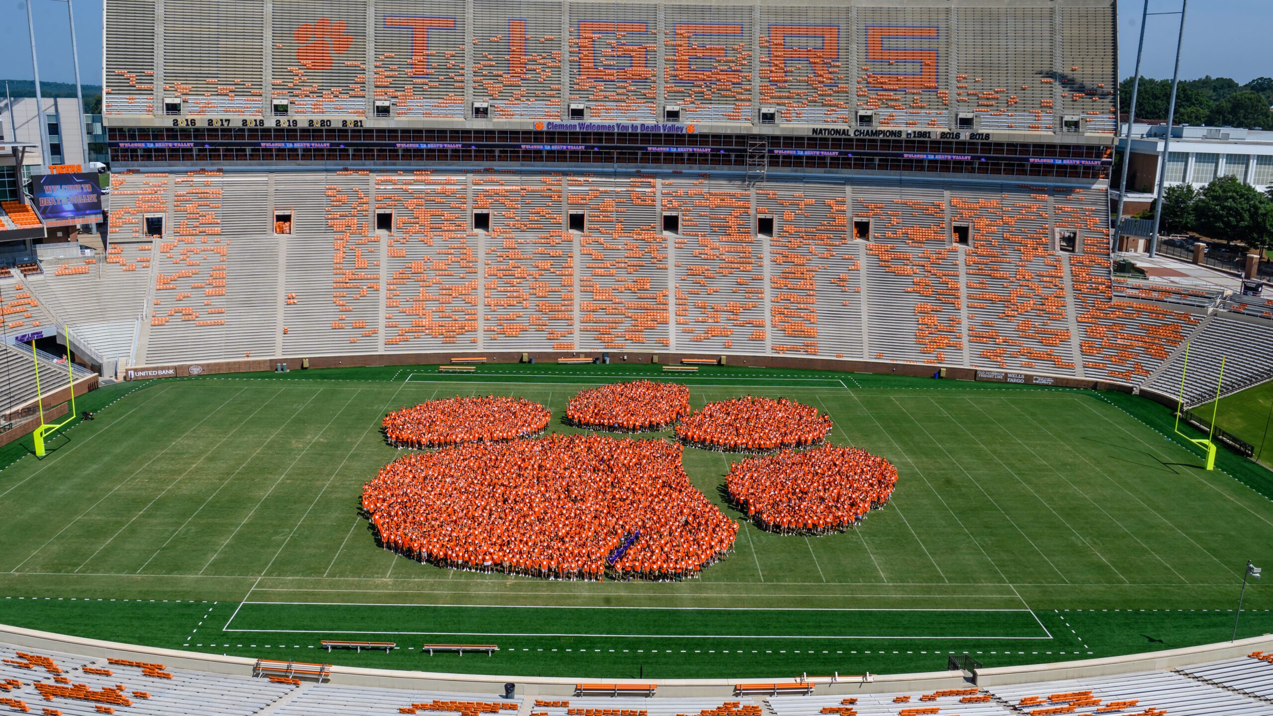 Members of the Class of 2027 make up the iconic Tiger Paw logo at midfield of Memorial Stadium