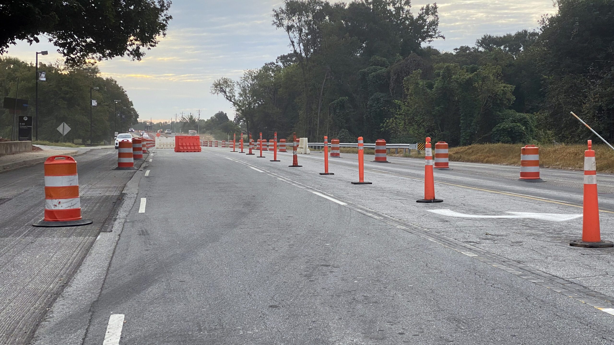 A view of Perimeter Road looking eastbound from the Williamson Road intersection. Orange barrels and cones line the median and lane markers