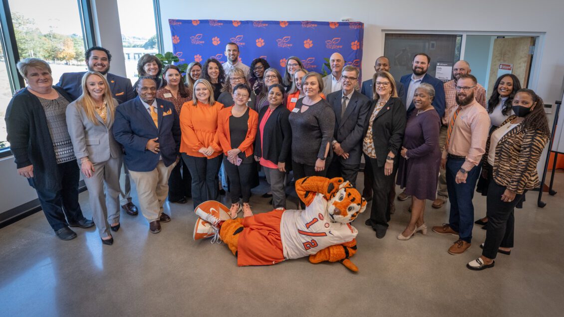 CU grow graduates gather for a group photo with President Clements and the Tiger mascot.