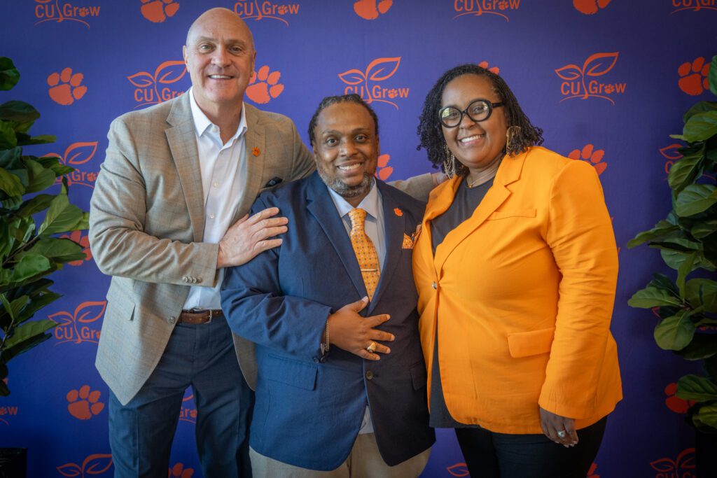 President Clements poses with two Clemson staff members.