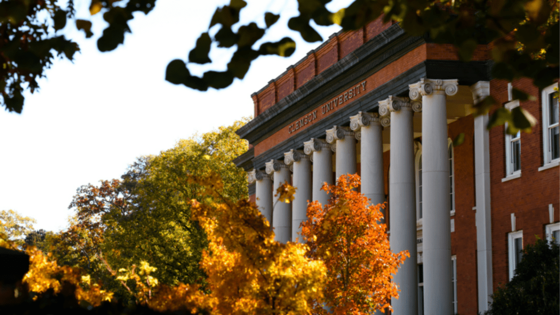 Sikes Hall surrounded by trees of various colors