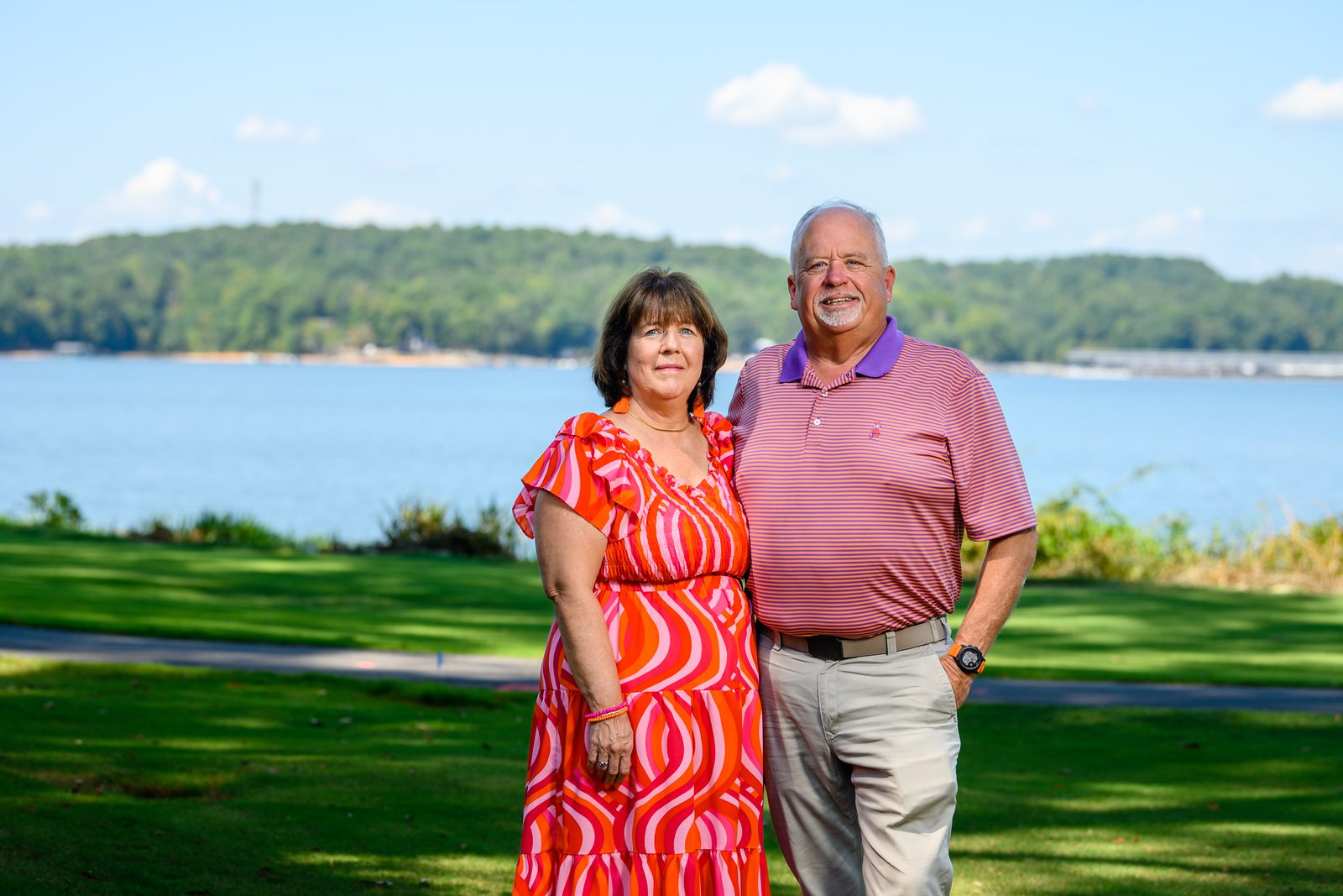 two people standing in front of lake