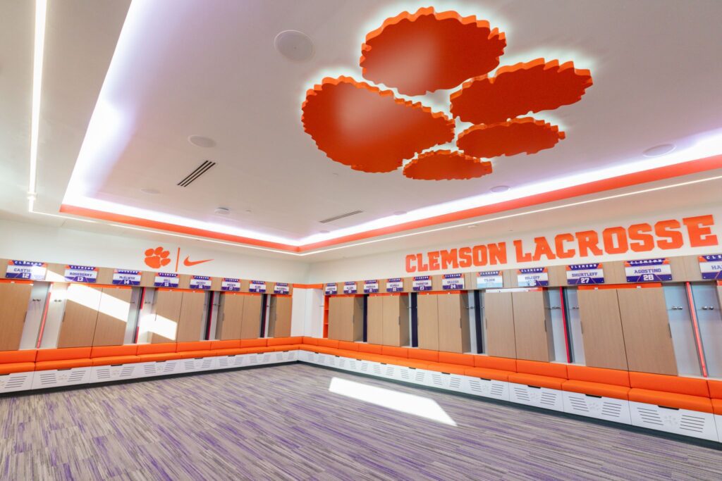 The Clemson lacrosse locker room with a Tiger Paw on the ceiling and orange sports lockers