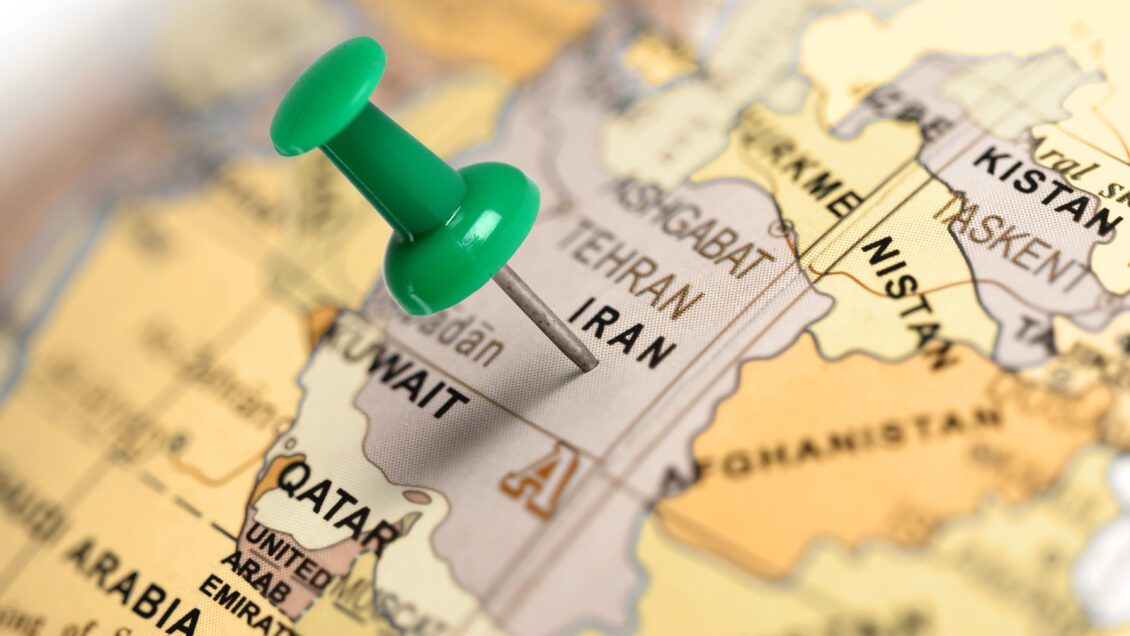A green pushpin is positioned on top of a map that is zoomed in on the country, Iran.
