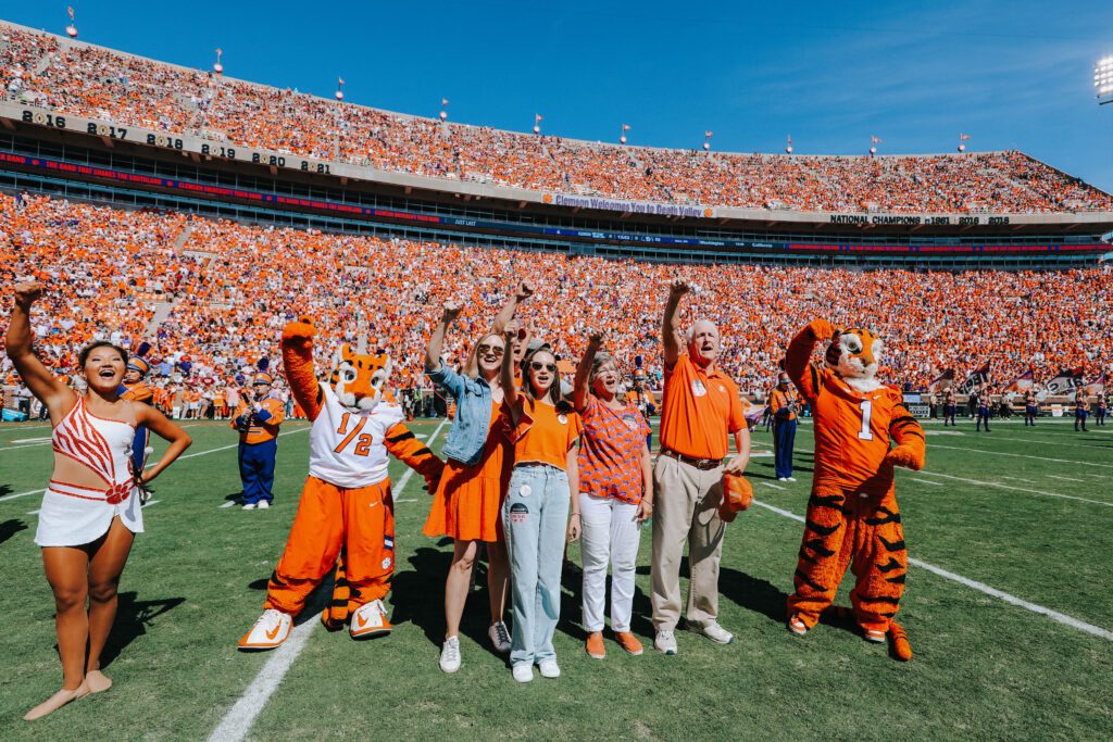 Dr. Sam Stone and his family dotted the I at a Clemson home football game this fall. He is shown with his family and the Clemson Tiger.