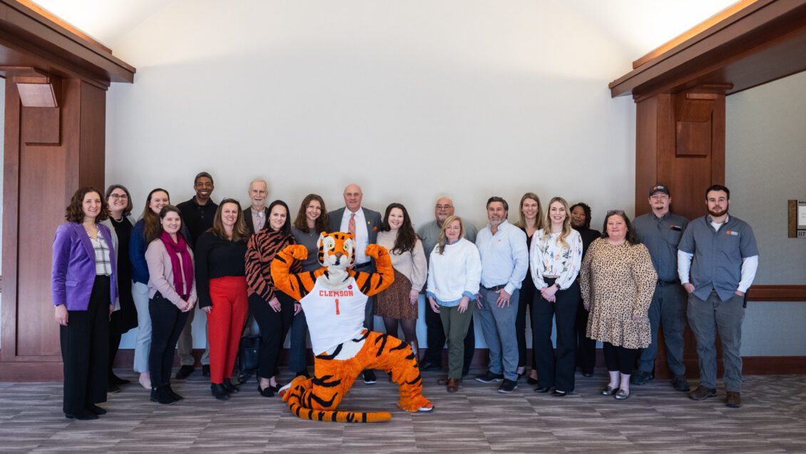A group of individuals pose with the Clemson Tiger at the degree attainment luncheon.