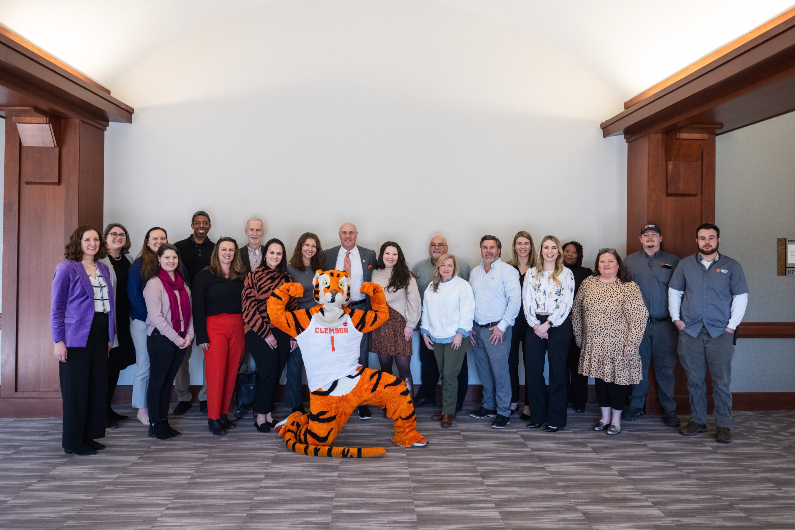 A group of individuals pose with the Clemson Tiger at the degree attainment luncheon.