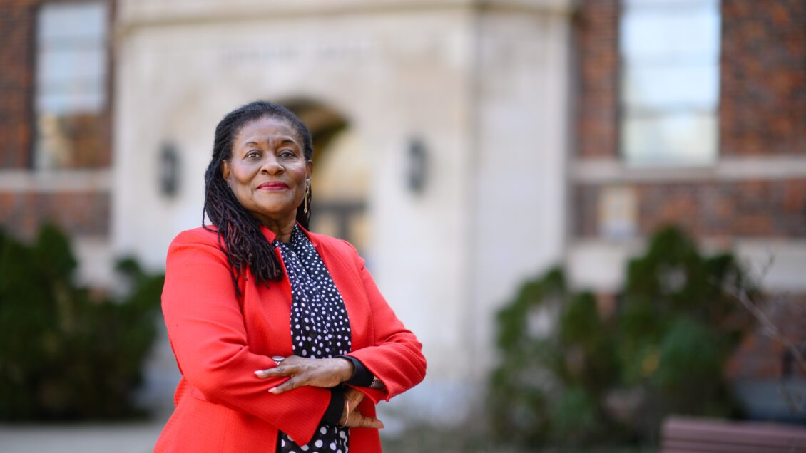 Paulette Ramsay crosses her arms for a photo outside of Sikes Hall on a mild February morning.