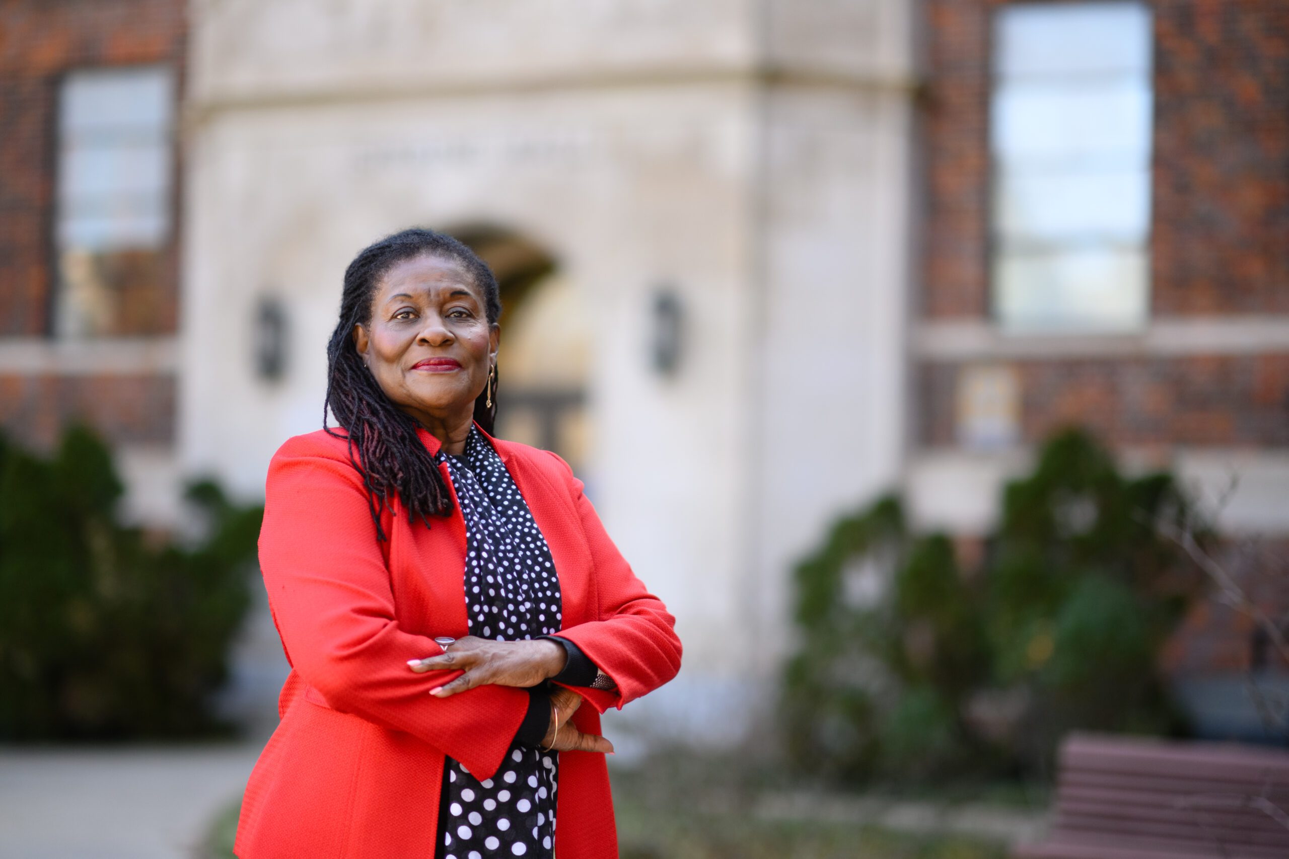Paulette Ramsay crosses her arms for a photo outside of Sikes Hall on a mild February morning.