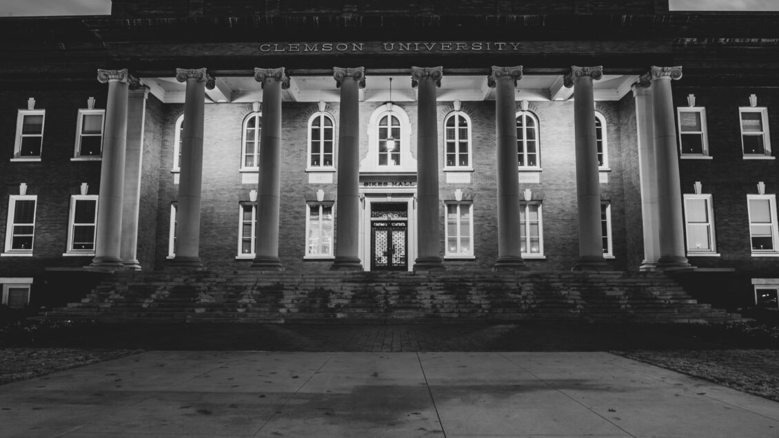 Black and white photo of a building with Dorian columns.