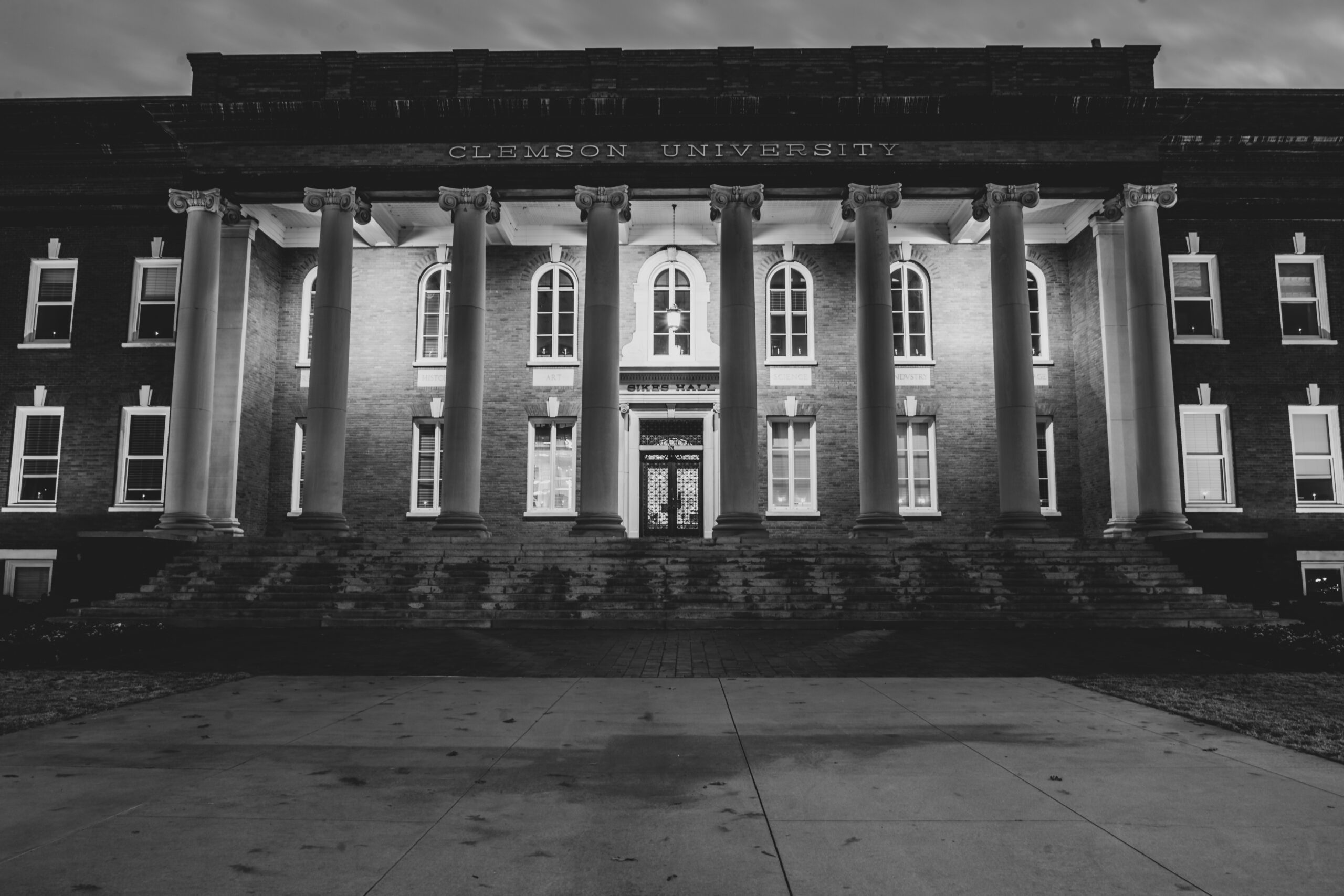 Black and white photo of a building with Dorian columns.