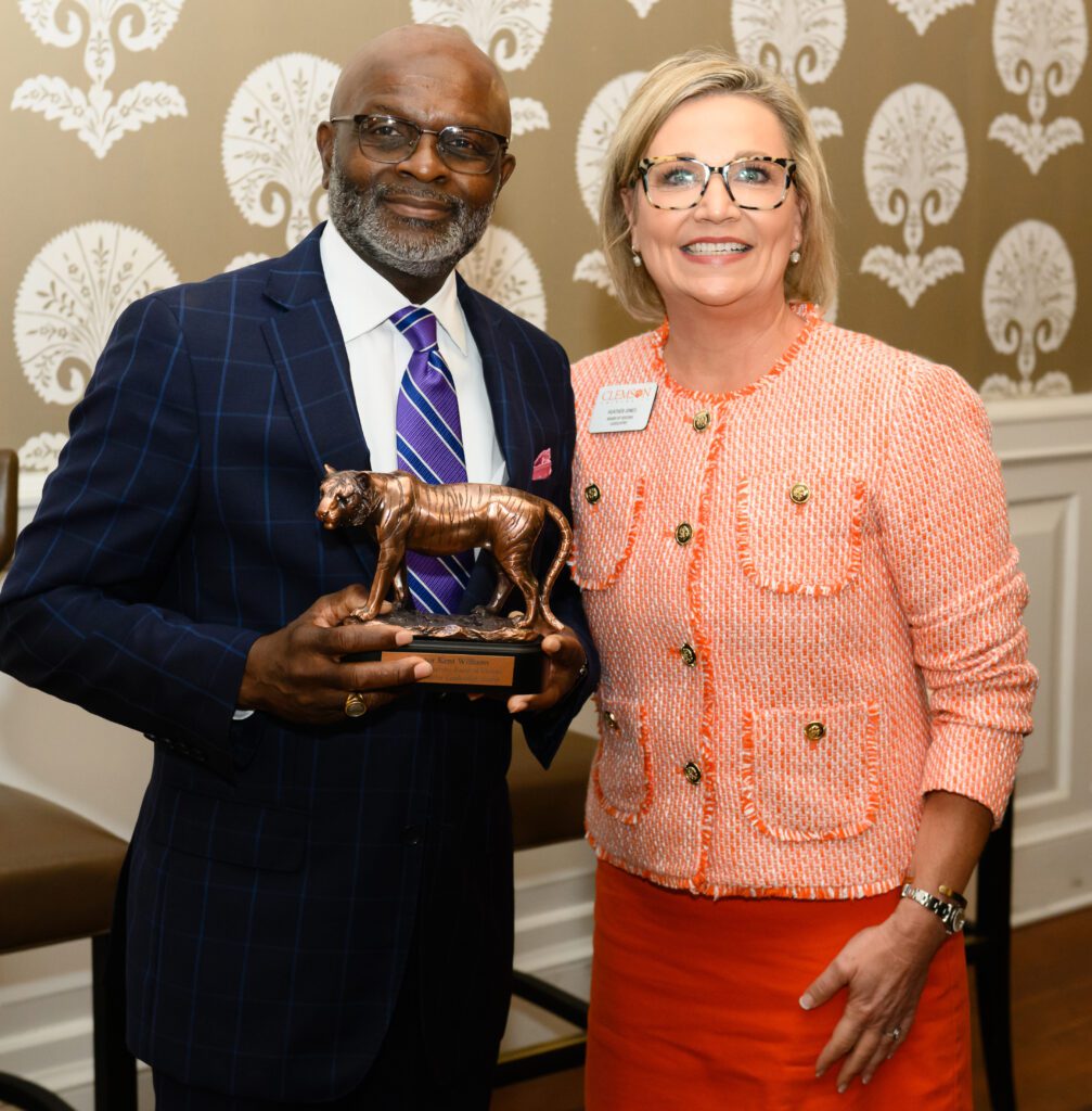 Sen. Kent Wilkins receives the Board of Visitors Legislative Leadership Award from Heather Simmons Jones