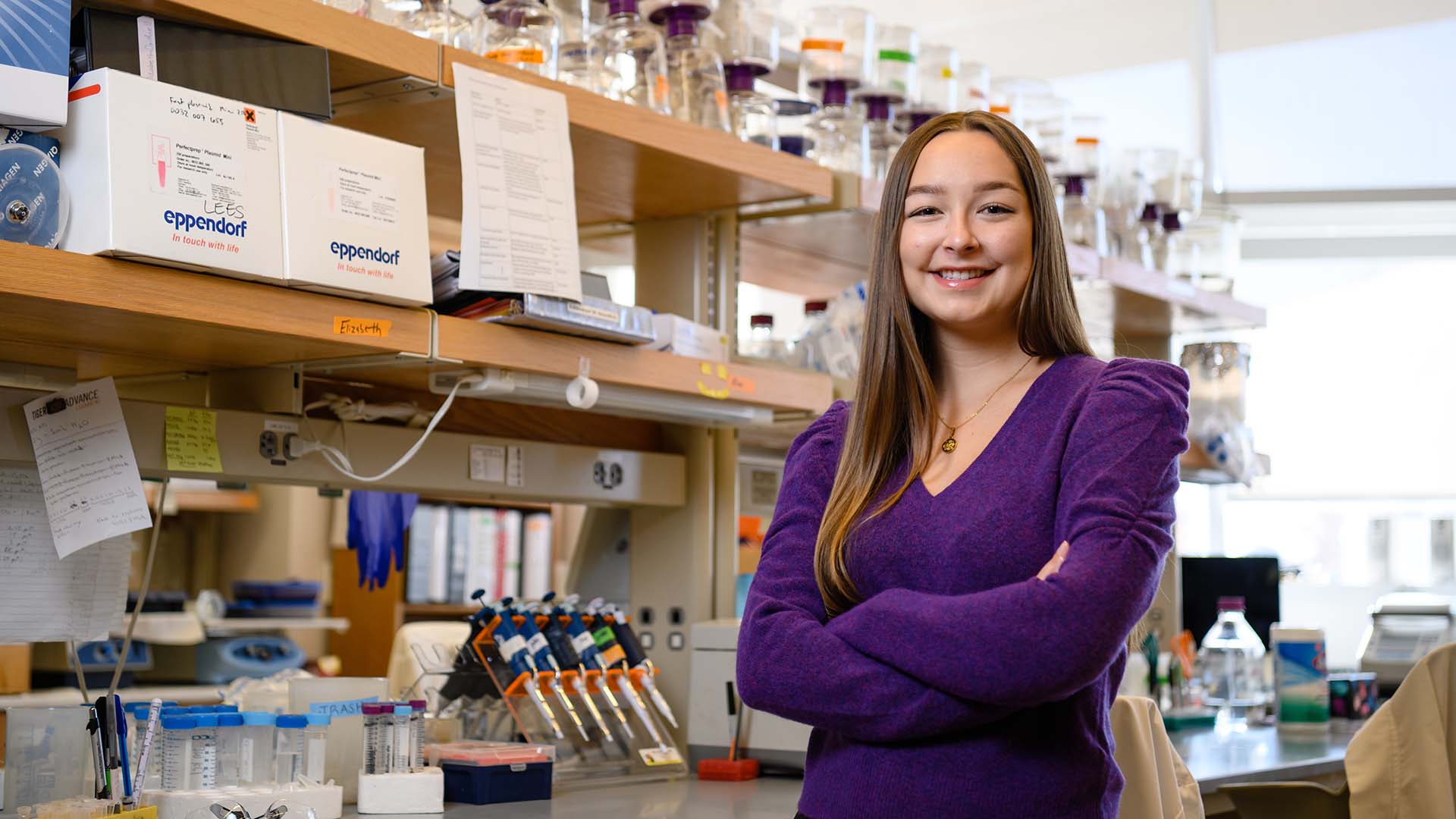 Honors student and Truman scholarship finalist Elizabeth Caldwell posing with her arms folded in a lab.