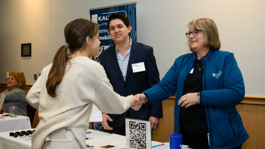 A student shakes the hand of a business person at a recent conference in the Hendrix Student Center.