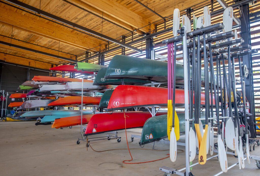 canoes, paddleboards, and kayaks stored at the Andy Quattlebaum Center at the Snow Complex