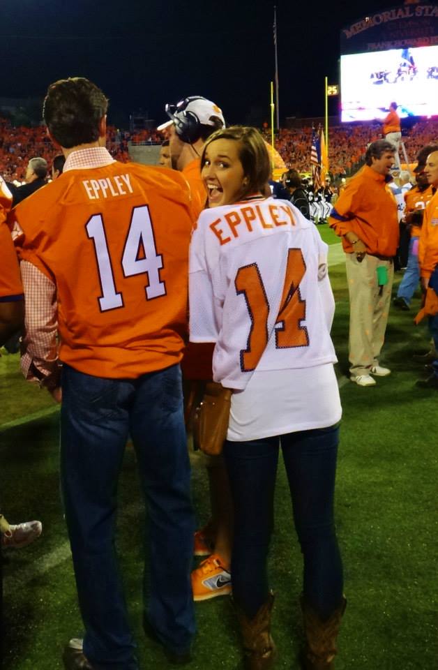Adrian and Mike Eppley are pictured wearing Clemson football "Eppley" jerseys at a home game inside Memorial Stadium at night.