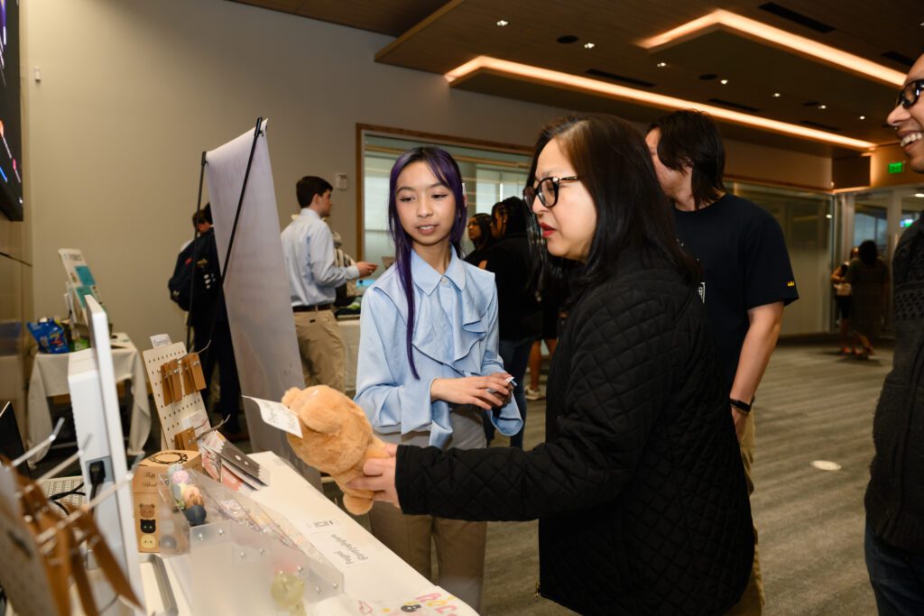 Lara Tijing, student at Clemson University, participates in a tradeshow to showcase her product.