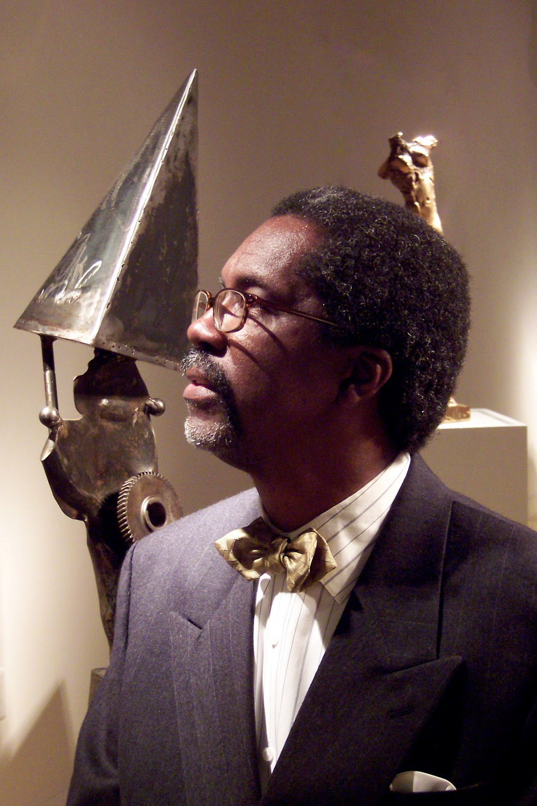 Winston Wingo's Portrait with metal sculptures in background