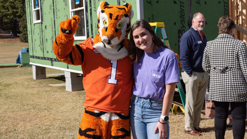 Katherine Harland smiles next to a Clemson Tiger mascot.