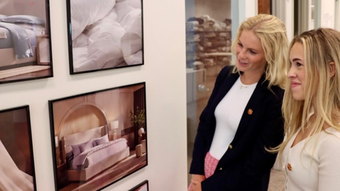 Two Clemson students look at photography at Boll & Branch.