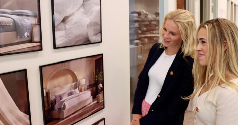 Two Clemson students look at photography at Boll & Branch.