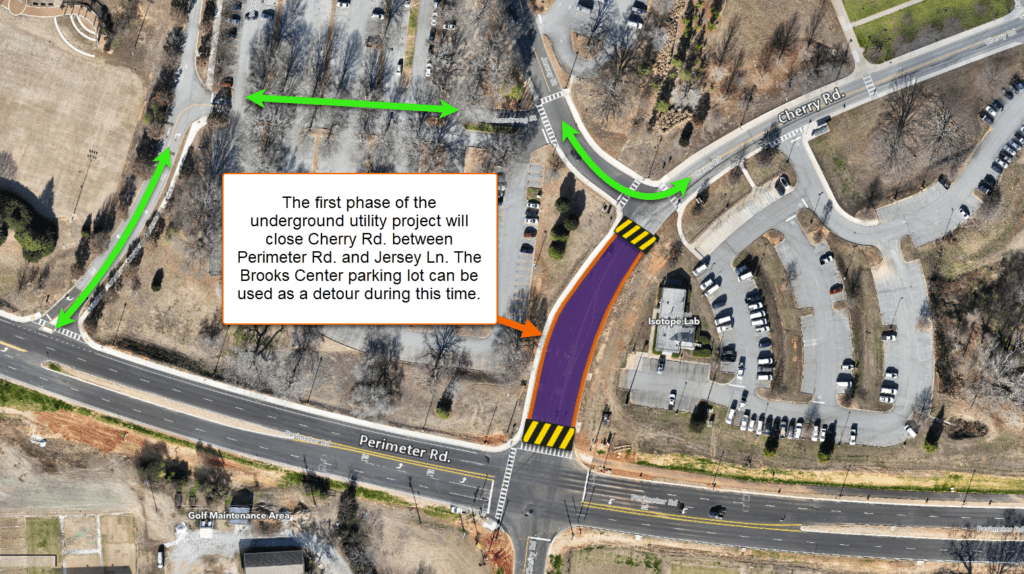 A traffic diagram showing one section of roadway in purple. A text overlay reads: The first phase of the
underground utility project will close Cherry Rd. between
Perimeter Rd. and Jersey Ln. The Brooks Center parking lot can be used as a detour during this time.