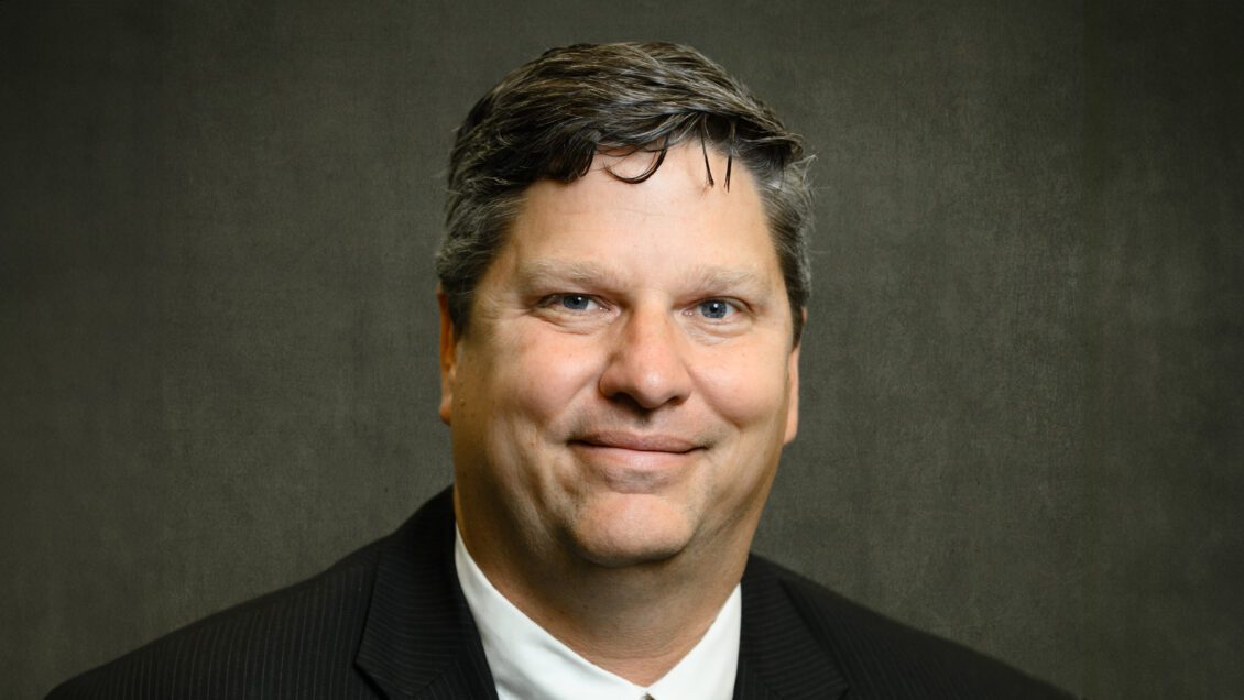 A close-up view of smiling man wearing a suit