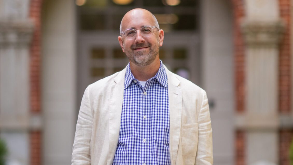 Ben White, Chair of the Clemson University Department of Philosophy and Religion, smiles outside historic Hardin Hall