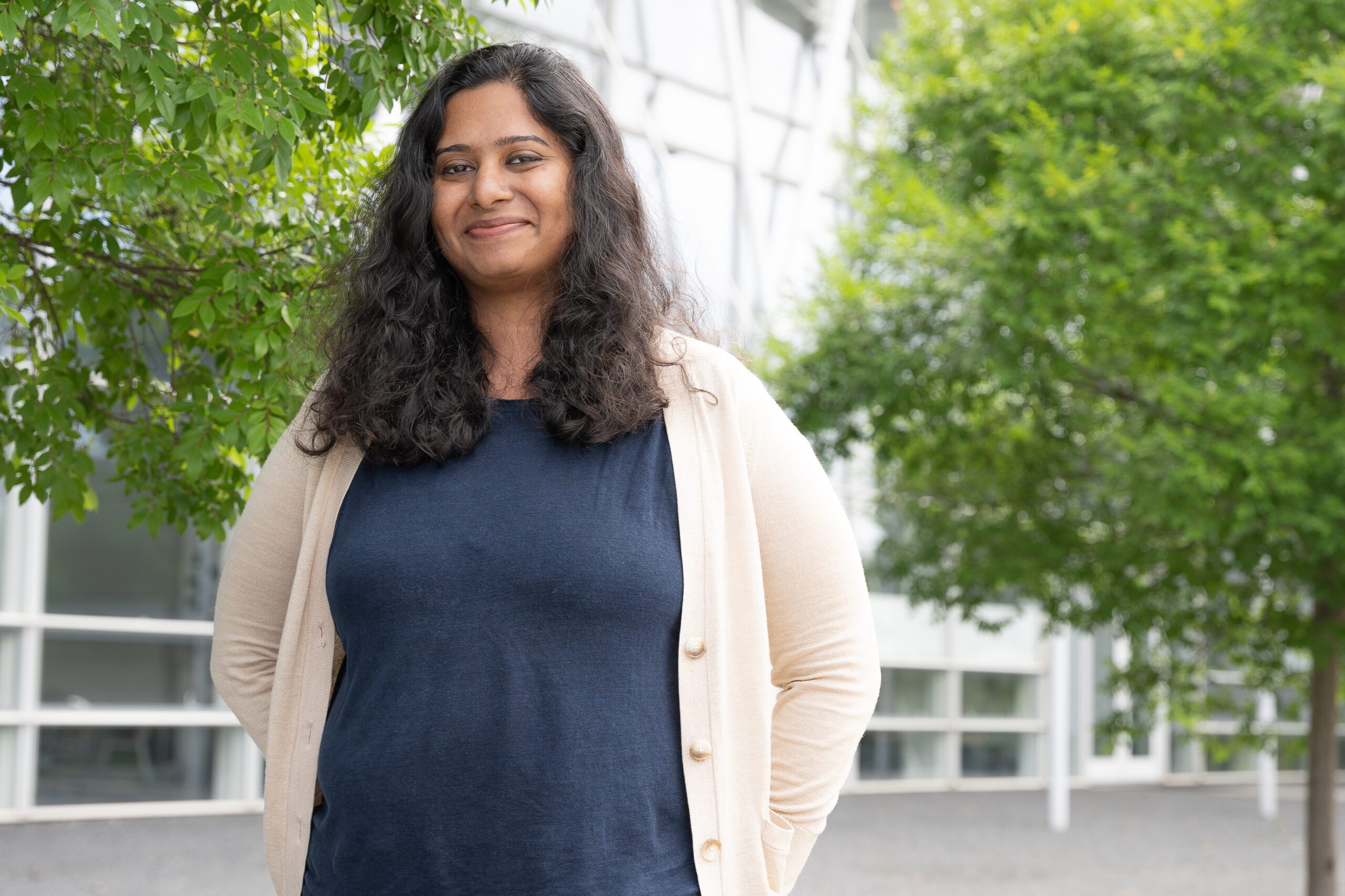 Devi Soman, an architecture + health Ph.D. student, smiling at the camera.