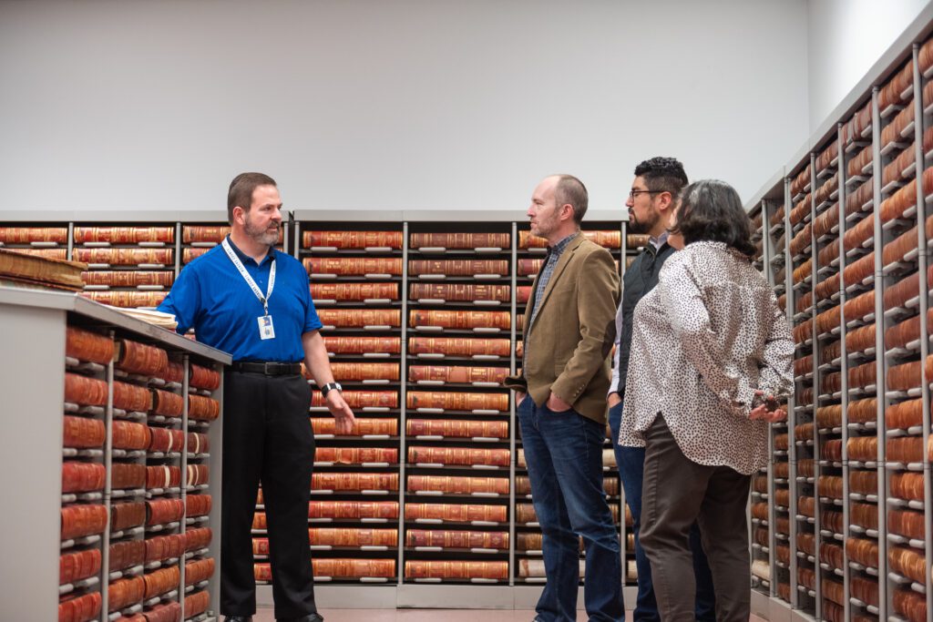 Pickens County Register of Deeds department head Paul McGuffin (far left) speaks with Department of History Professor J. Brent Morris (middle), R.M. Cooper Library Head of Digital Strategies Christopher Vinson and Department of English Professor Susanna Ashton (far right) in February 2024.