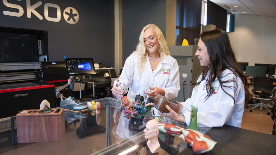 Two female students examining packaging innnovations.