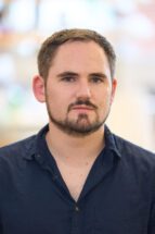 Headshot of man wearing a black shirt