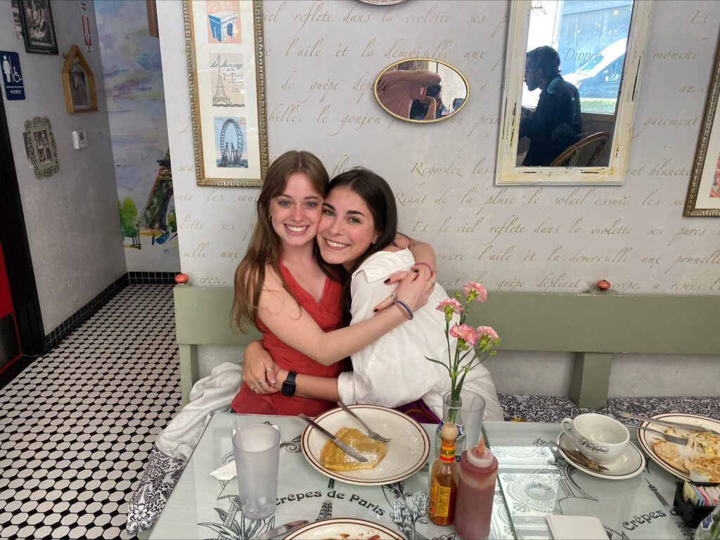 Sydney Olsen is pictured hugging world cinema sophomore Diana Wells in Crêpes de Paris in Los Angeles. 