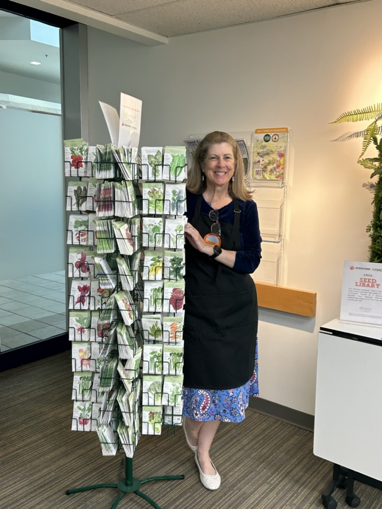 Tri County Master Gardener Elizabeth Connor is ready to help clients select free seed packets from the seed library in Clemson Extension's TEACH Center in the Citadel Mall, Charleston.