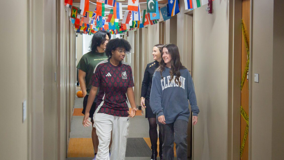 Students walk down the hallway of Passport Living learning community