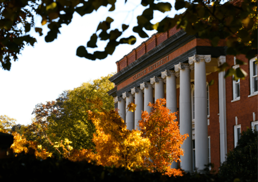 Sikes Hall surrounded by trees in the fall.