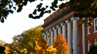 Sikes Hall surrounded by trees in the fall.