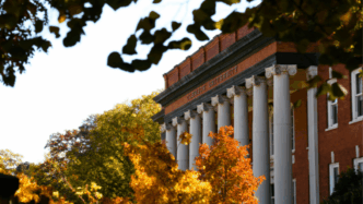 Sikes Hall surrounded by trees in the fall.