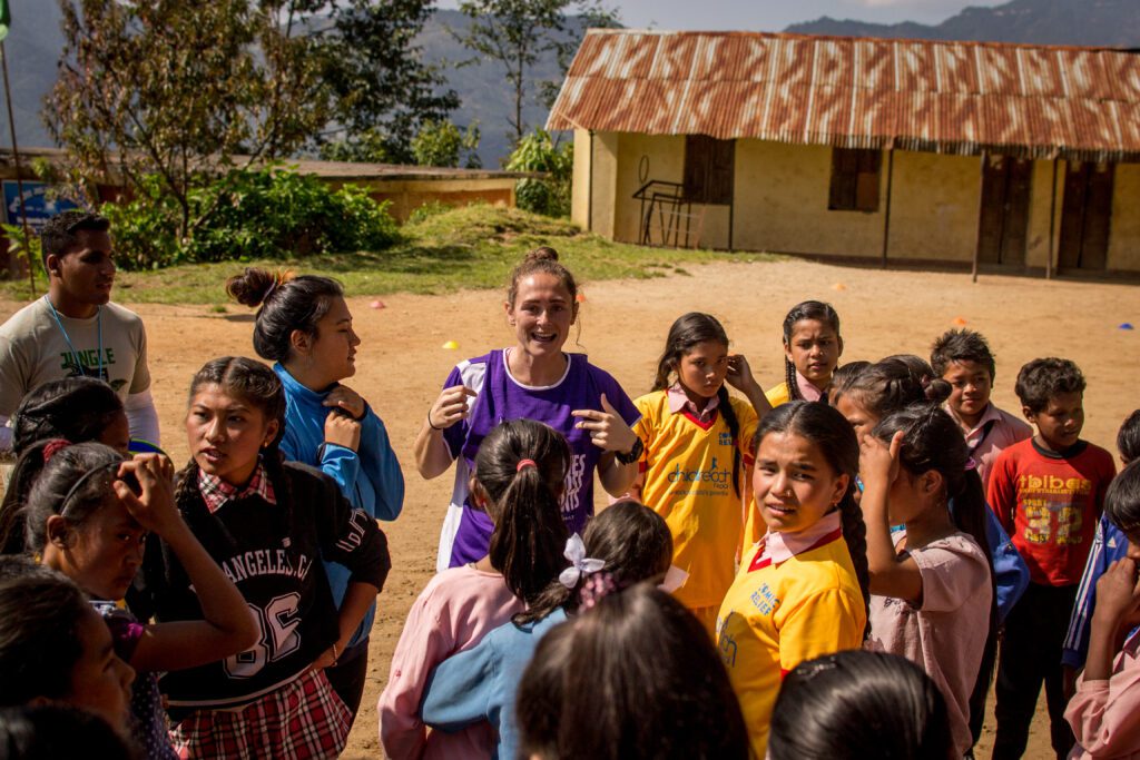 Hardie and children from Nepal gather outside