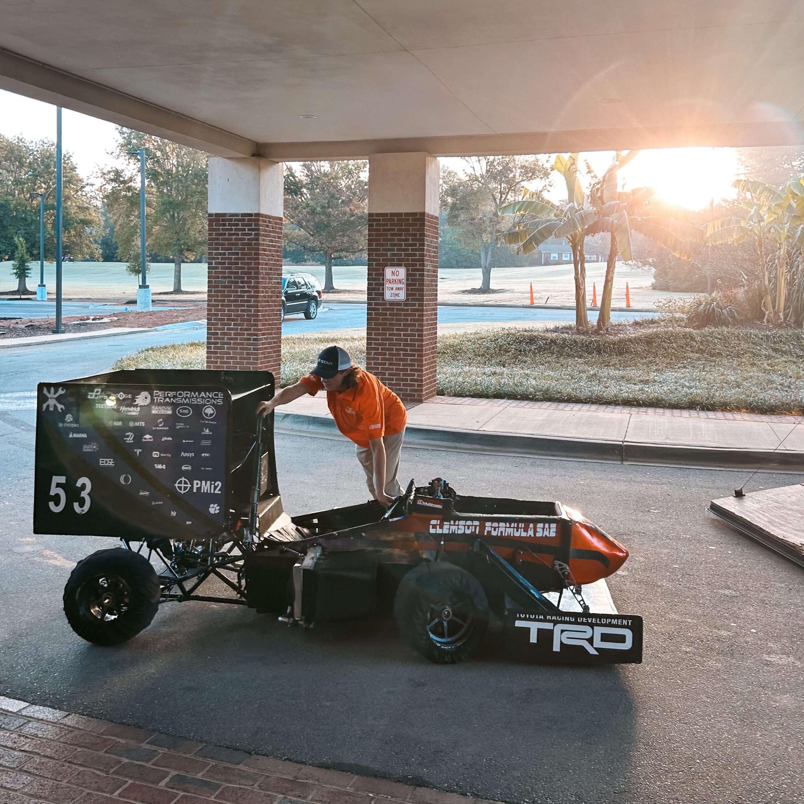 An automotive student unloads a formula one race car