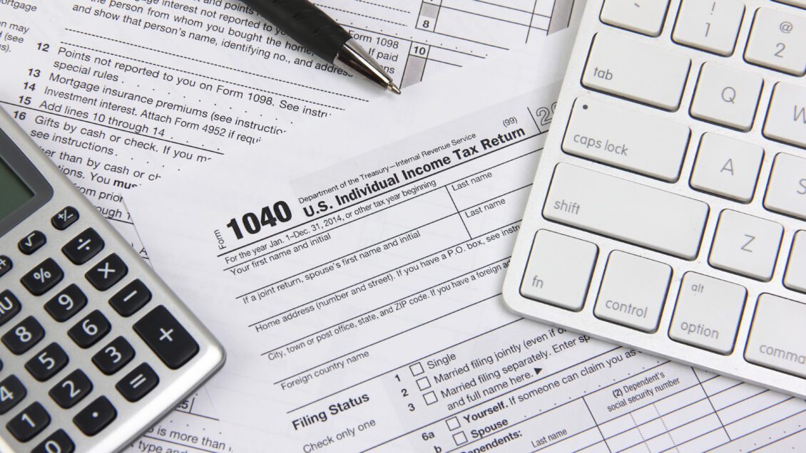 Technology and paperwork showing tax filing and tax preparation