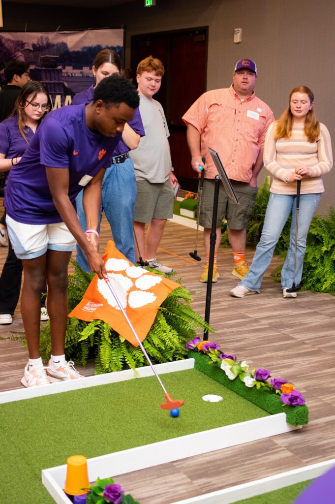 Attendees play mini golf at the RECESS symposium