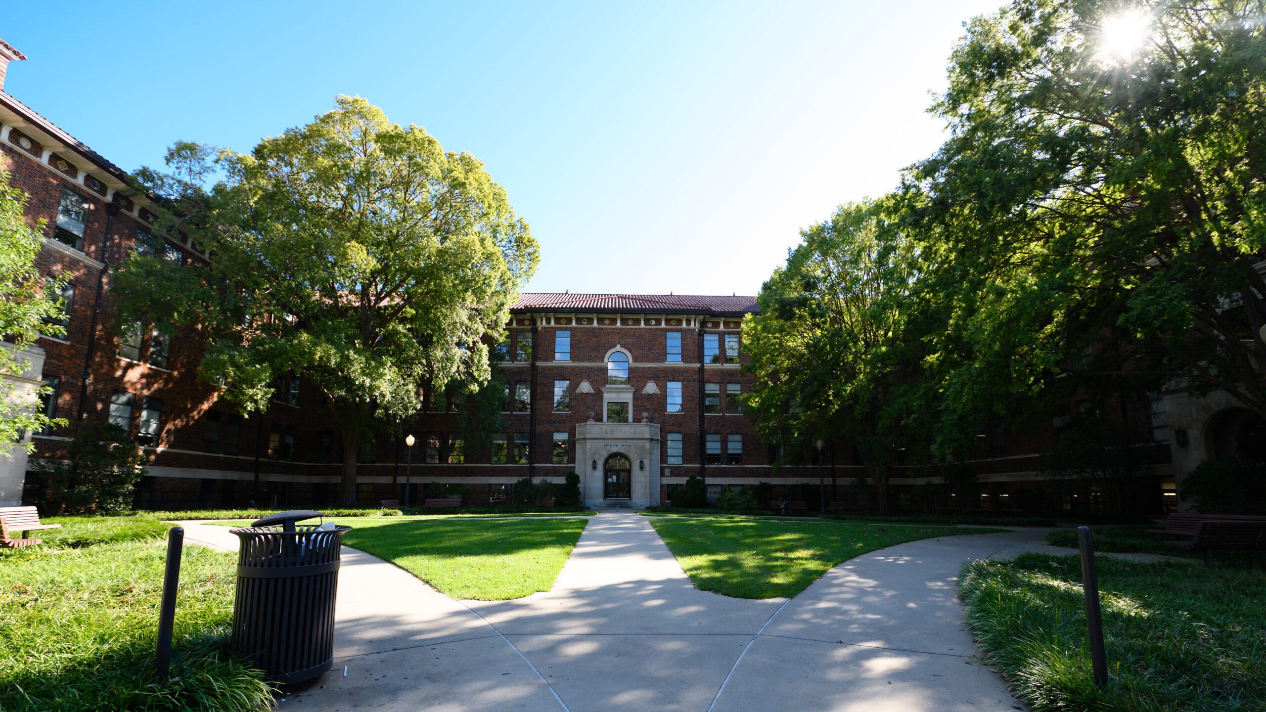 A brick building surrounded by trees